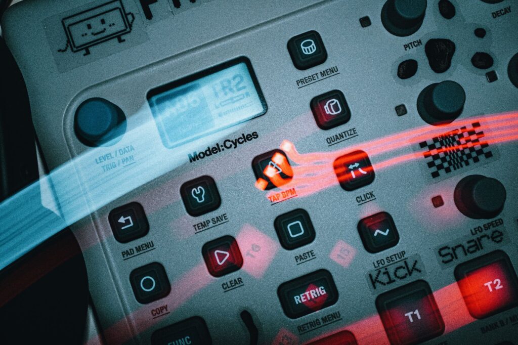 Detailed view of an electronic music sequencer with buttons and dials, showcasing a sleek design.