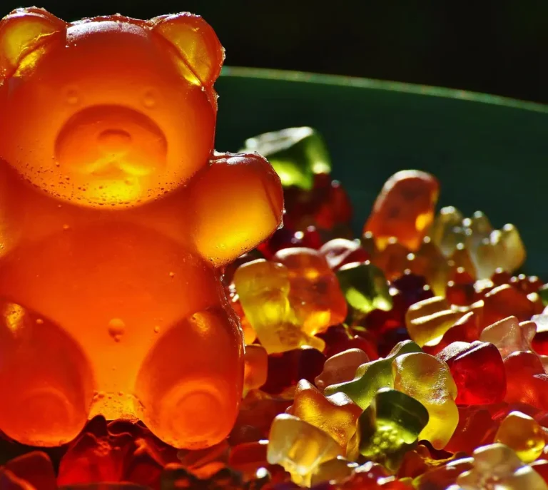 Vibrant gummy bears in sunlight showcasing textures and colors in an outdoor setting.
